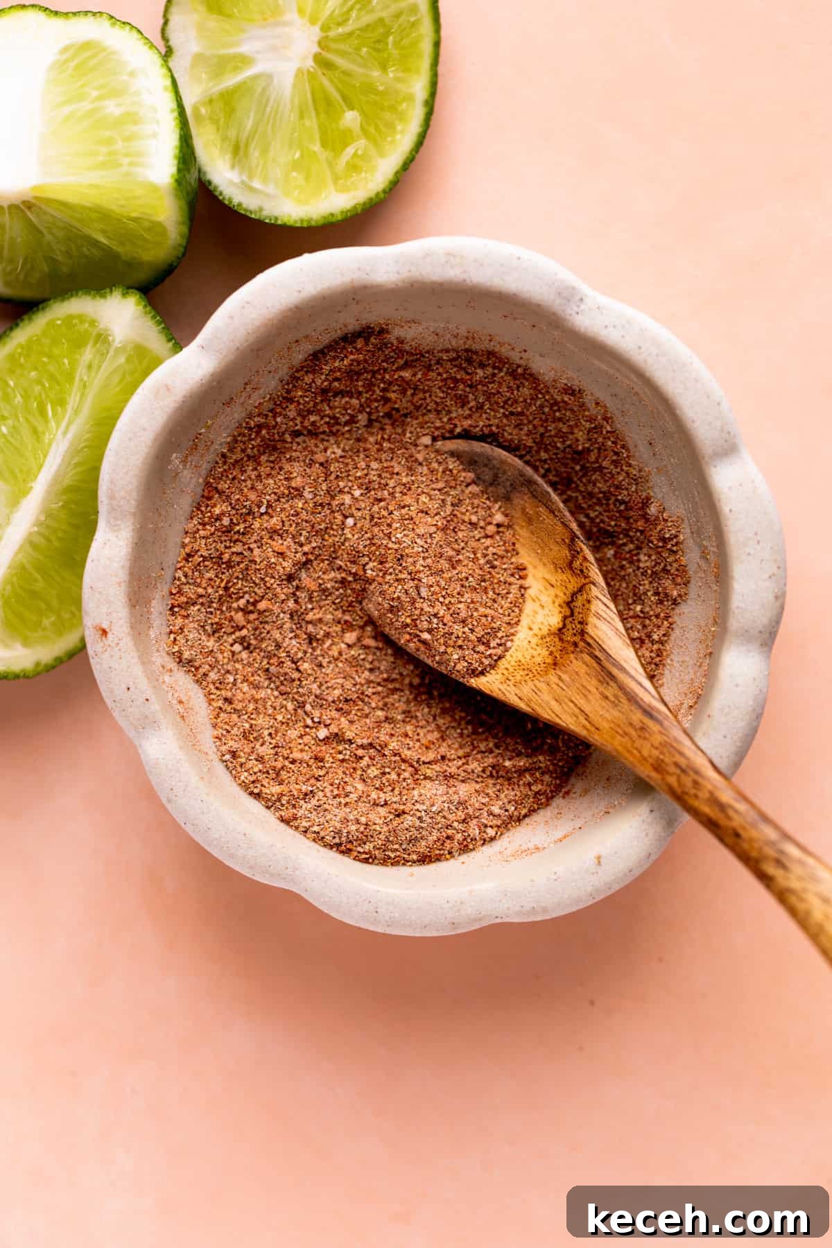 Bowl of fish taco seasoning mixed with a wooden spoon.