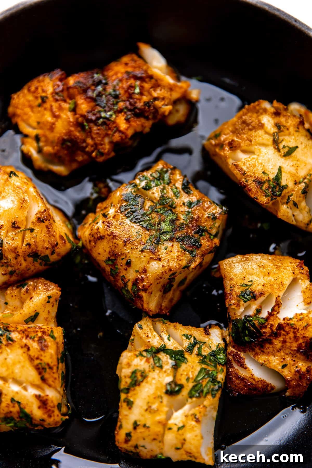 Fish searing in a cast iron skillet.
