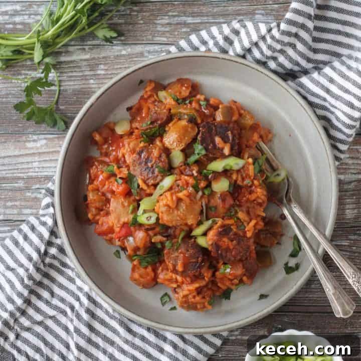 Two forks in a finished dish of vegan jambalaya.