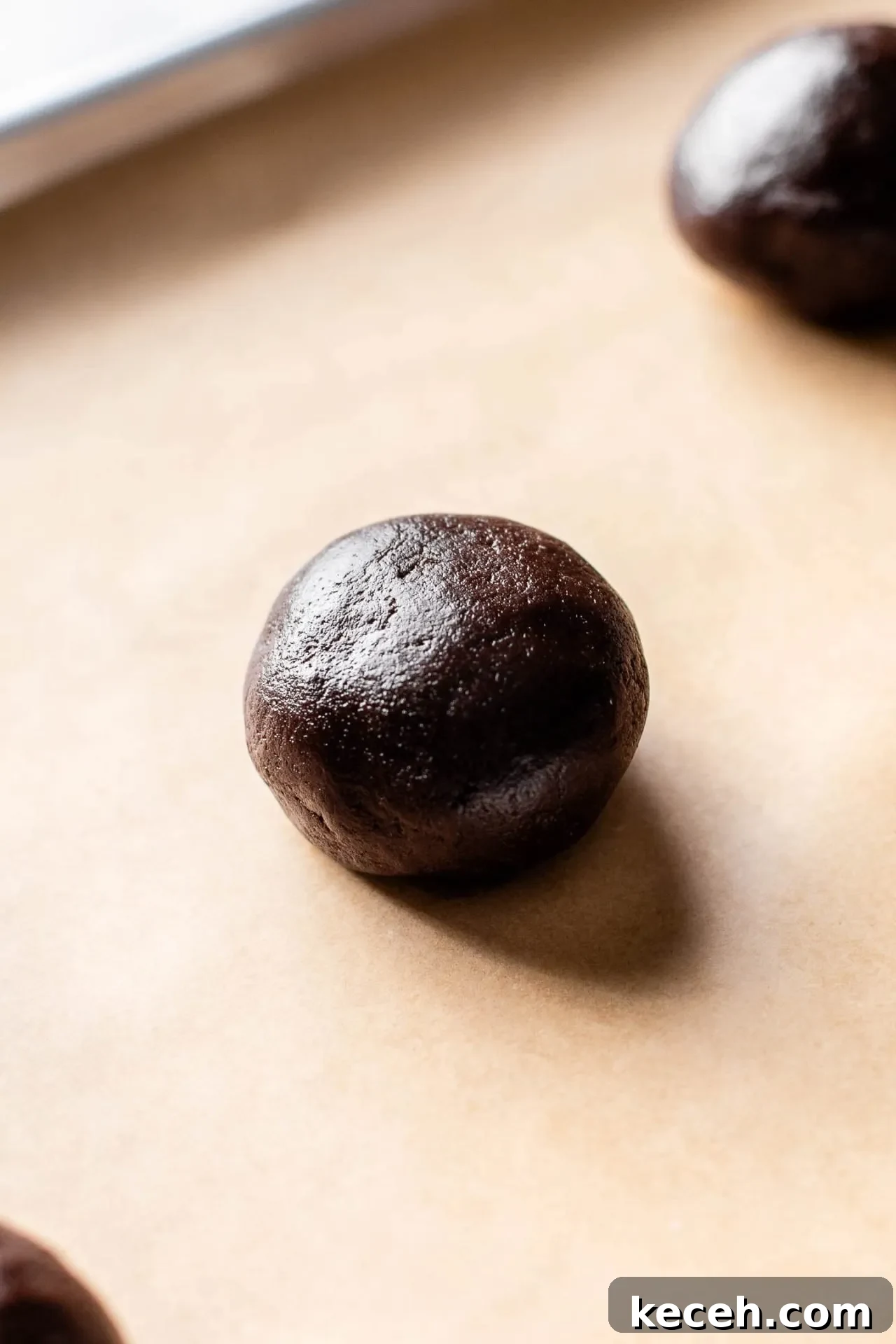 Molten Nutella Chocolate Lava Cookies: Gooey Center Cookie Recipe 12 Nutella stuffed chocolate cookie dough ball on parchment lined baking sheet