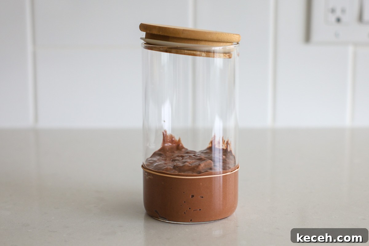 Sourdough Chocolate Starter: How to Make It and What to Use It For 4 Chocolate sourdough starter after a feeding in a jar, with rubber band.