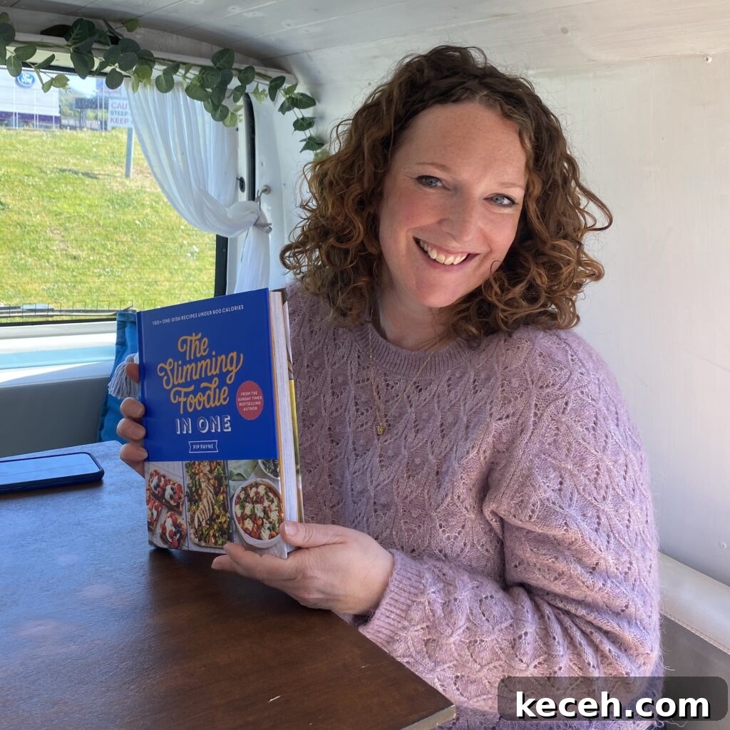 Curried Chicken Tray Bake Recipe from The Slimming Foodie 3 Cookbook author Pip Payne holding her second book The Slimming Foodie in One