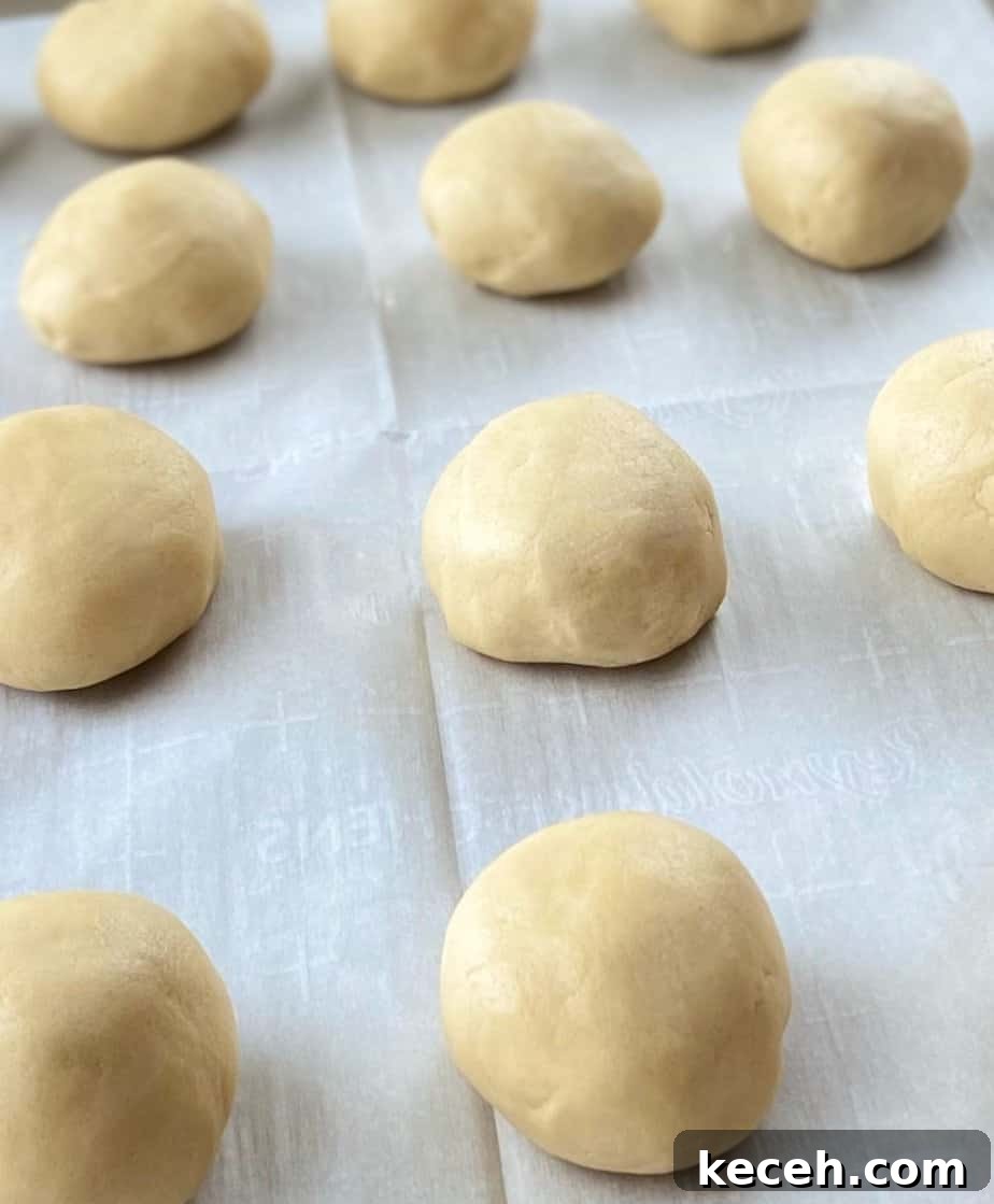 Perfect Cookie Dough Recipe for Baking and Safe Snacking 7 Cookie dough ball on baking sheet.