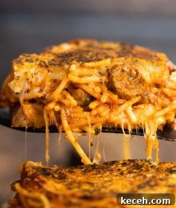 Spaghetti sandwich close up shot of black spatula lifting spaghetti sandwich showing filling