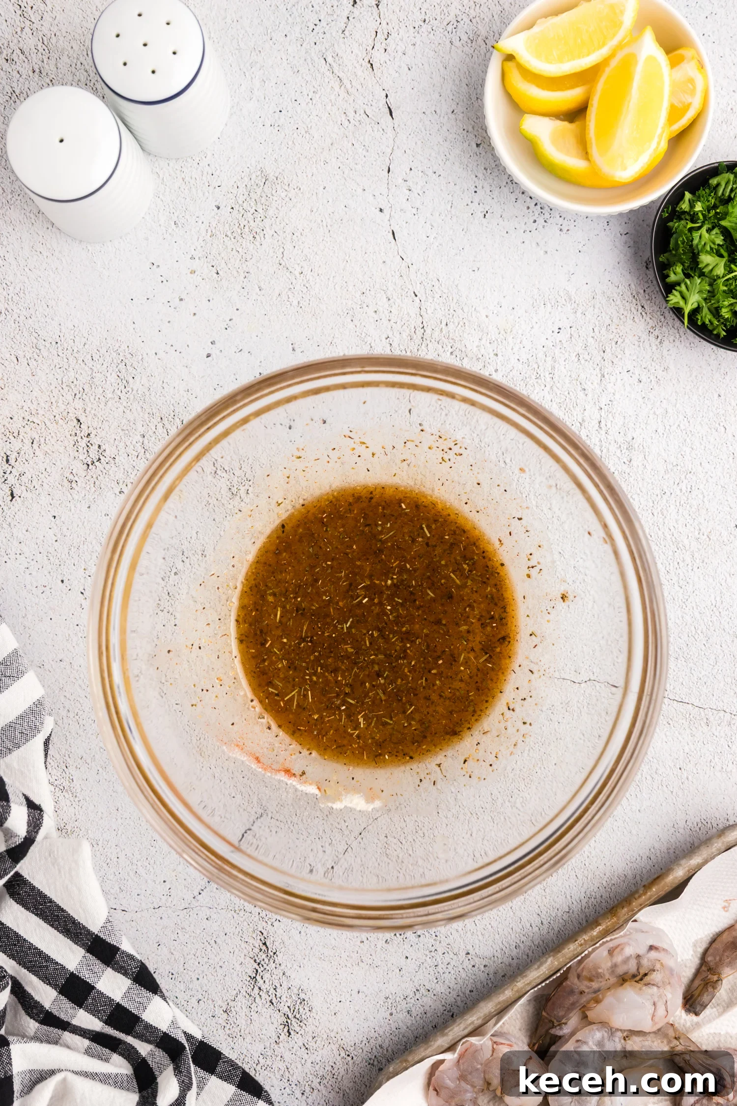 Crispy Blackstone Grilled Shrimp with Garlic Butter Sauce 6 Seasoning mixture blended into a marinade inside a glass mixing bowl.