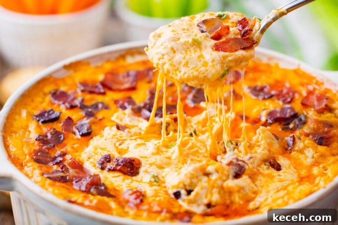 One-Bowl Buffalo Chicken Dip Recipe for Game Day 3 A spoonful of very cheesy Buffalo crack chicken dip.
