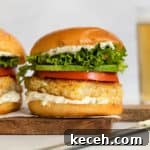 Crispy Oven-Baked Fish Sandwiches You’ll Crave 11 Crispy fried fish sandwich with tomato, avocado, and lettuce on a toasted bun