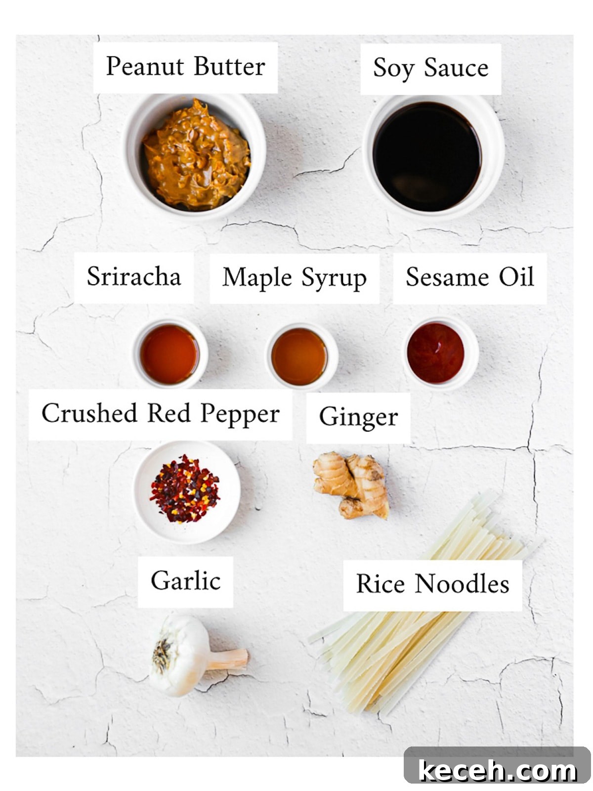 Spicy Peanut Noodle Recipe: Creamy Chili Sesame Noodles 3 Labeled ingredients in small white bowls and on a white background including: peanut butter, soy sauce, sriracha, maple syrup, sesame oil, crushed red pepper, ginger, garlic, and rice noodles.