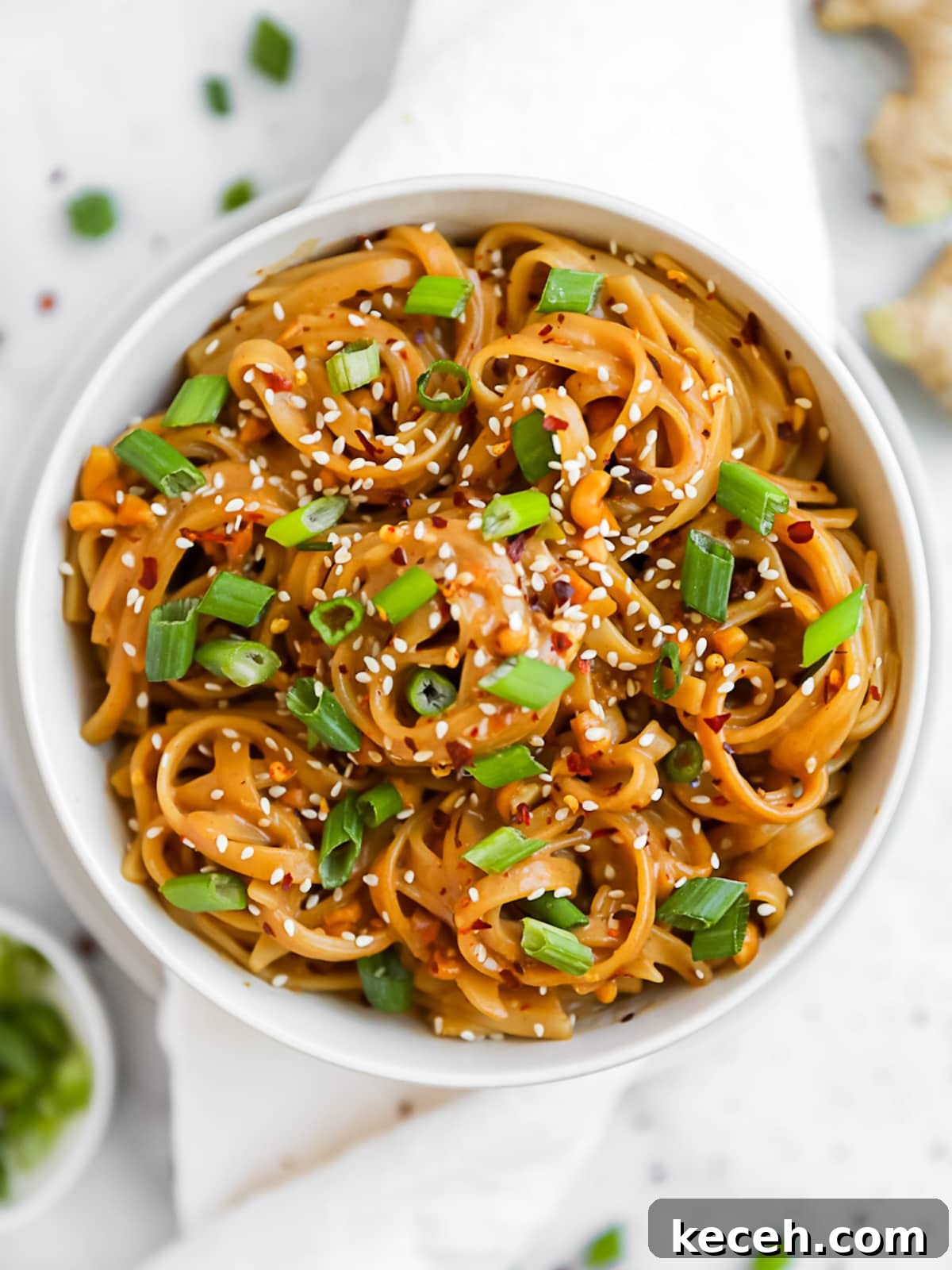 Spicy Peanut Noodle Recipe: Creamy Chili Sesame Noodles 5 Creamy peanut noodles in a white bowl.