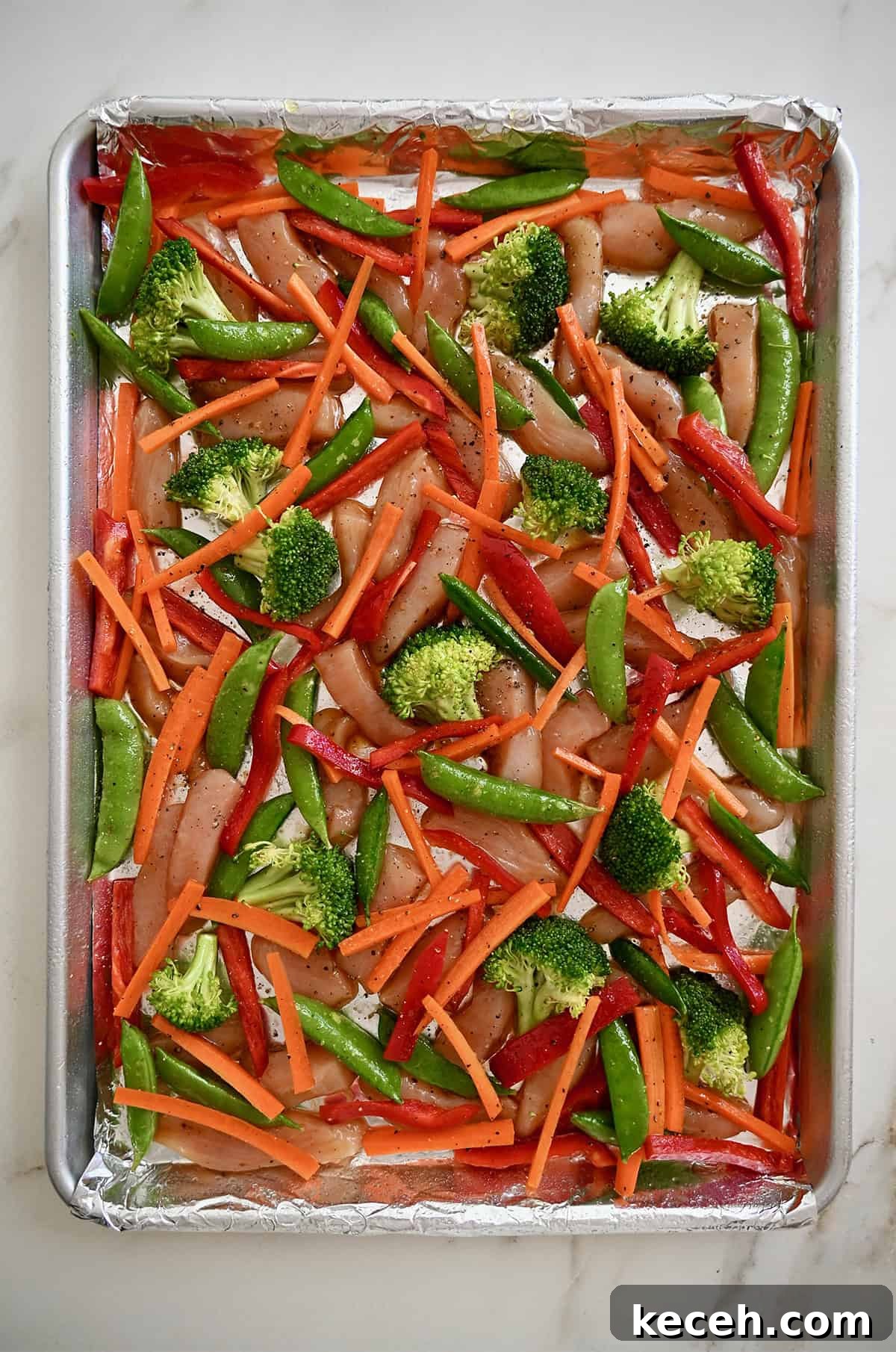 Sheet Pan Teriyaki Chicken with Roasted Vegetables 7 Unbaked chicken teriyaki on a foil-lined sheet pan before baking.