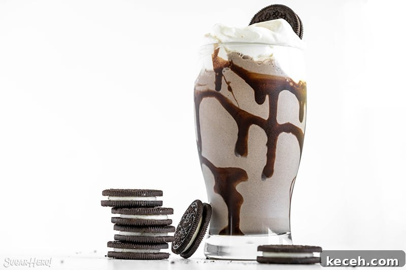 Creamy Oreo Milkshake Recipe for Homemade Dessert 4 Glass filled with Oreo Milkshake and topped with whipped cream and an Oreo cookie.