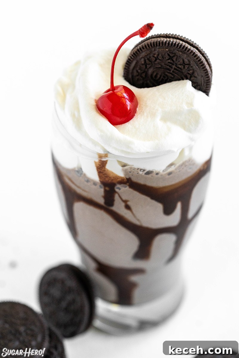 Creamy Oreo Milkshake Recipe for Homemade Dessert 8 Oreo Milkshake in a glass with whipped cream, a cherry on top, and an Oreo.