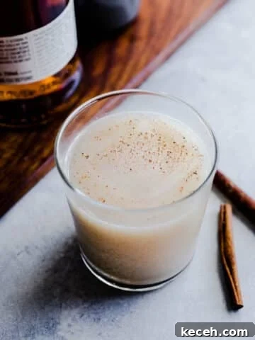 A cocktail garnished with nutmeg.