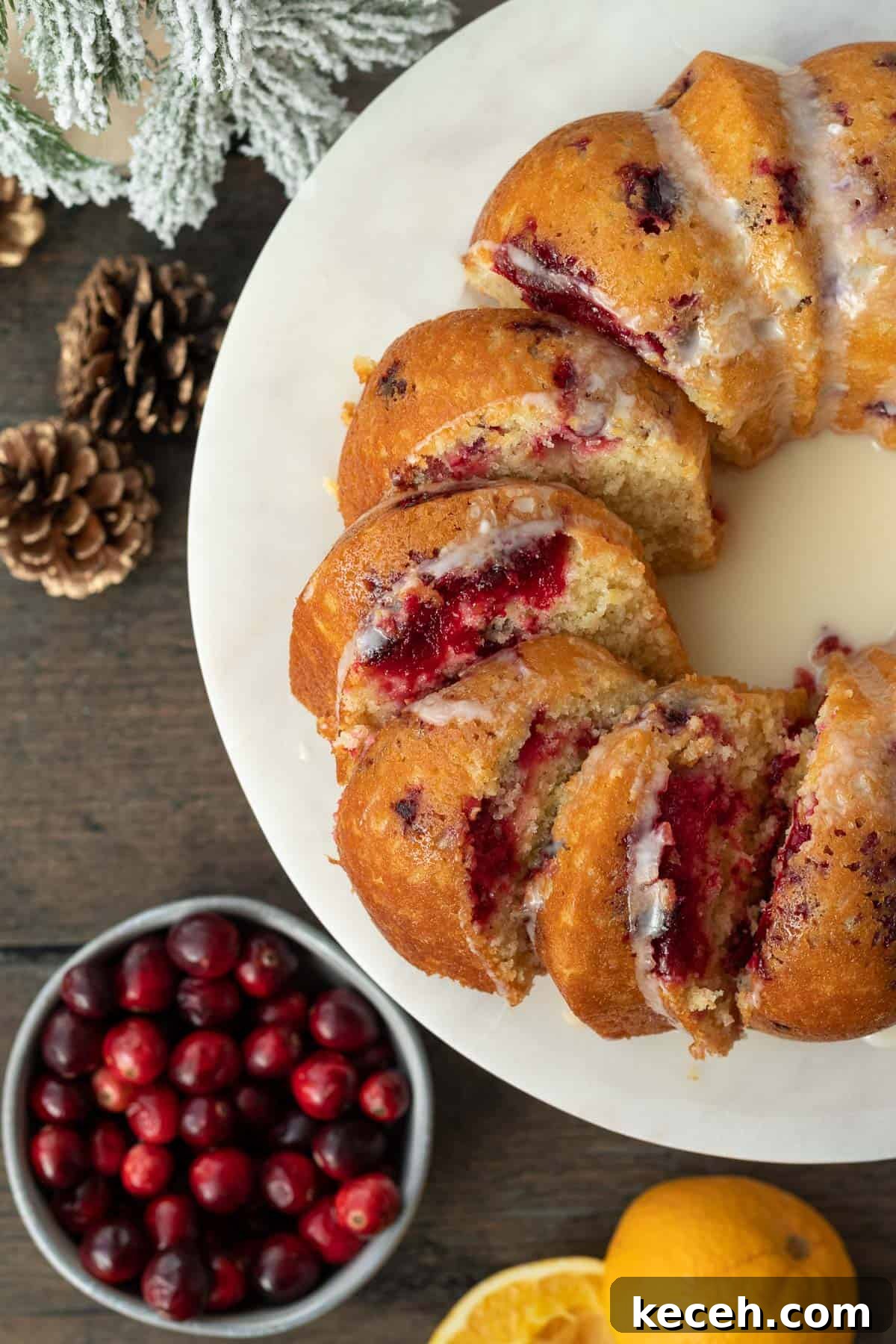 Cranberry-Orange Bundt Cake with Fresh Cranberry Sauce Swirl 2 cranberry orange bundt cake slice and spread out on a marble cake stand