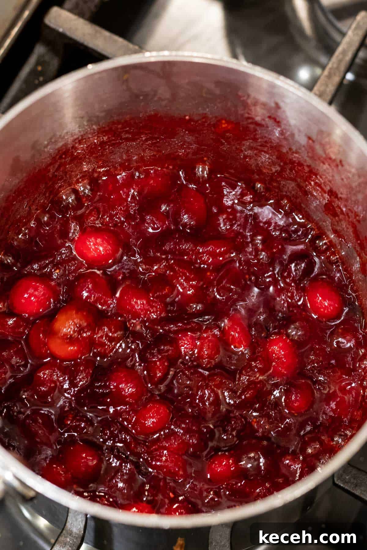 Cranberry-Orange Bundt Cake with Fresh Cranberry Sauce Swirl 4 cranberry sauce in a silver saucepan