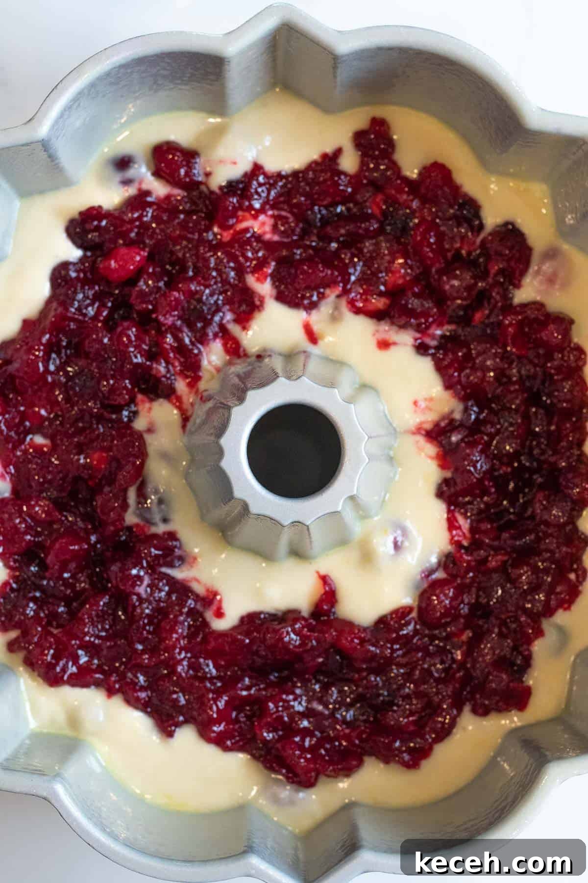 Cranberry-Orange Bundt Cake with Fresh Cranberry Sauce Swirl 6 cranberry orange cake batter in a bundt pan layered with cranberry sauce