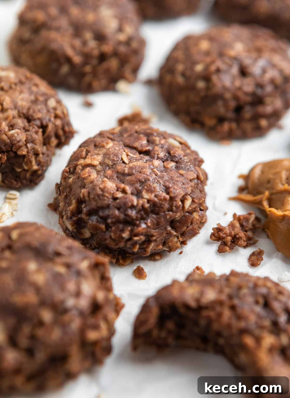 No-Bake Cookie Butter Treats: Quick No-Oven Dessert Recipe 9 Cookie butter cookies laying on parchment with bite taken out of one cookie.