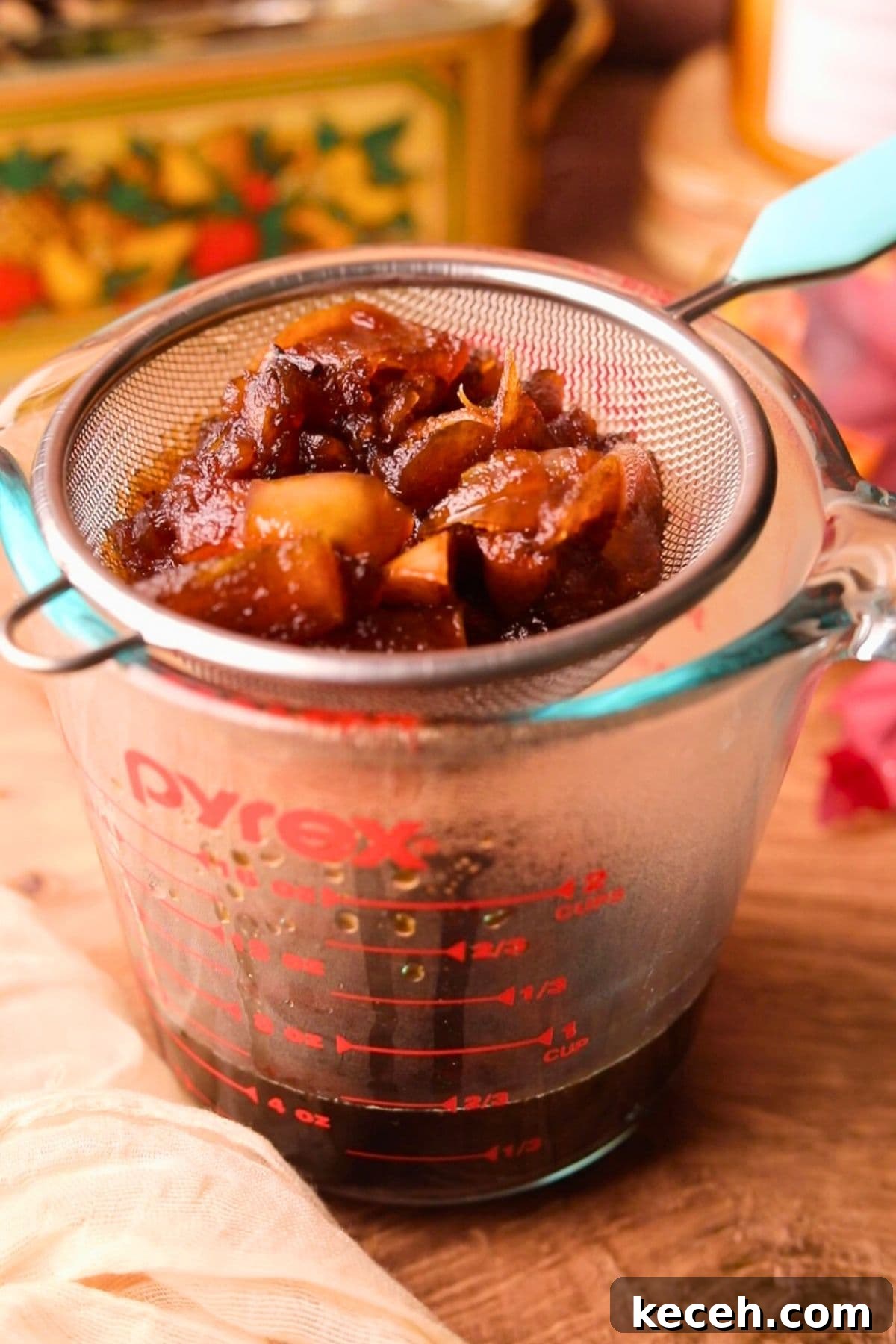 Apple and Brown Sugar Syrup Recipe for Pancakes & Coffee 6 apple brown sugar syrup in a mesh strainer.