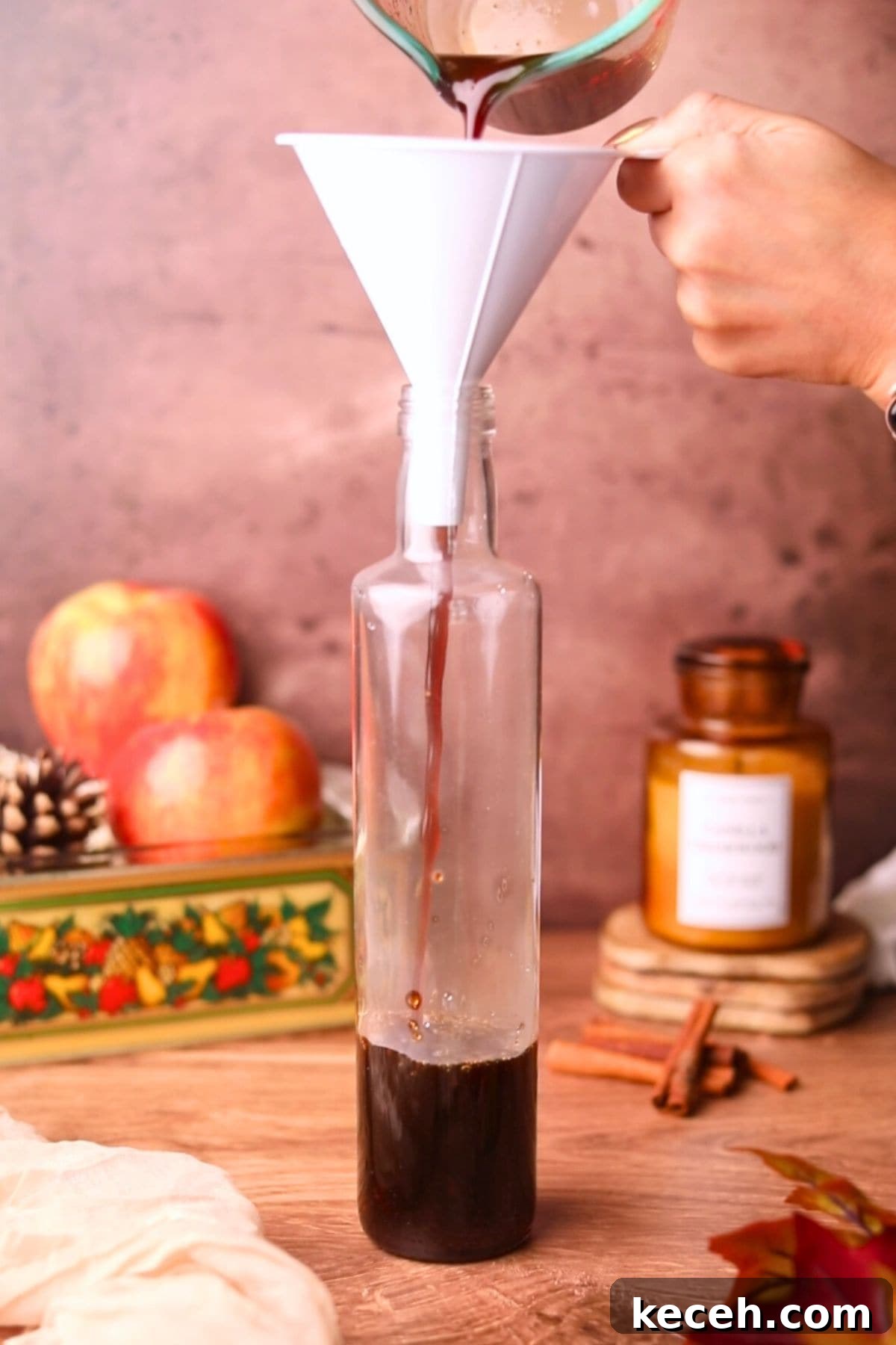 Apple and Brown Sugar Syrup Recipe for Pancakes & Coffee 7 apple brown sugar syrup being poured into a bottle.