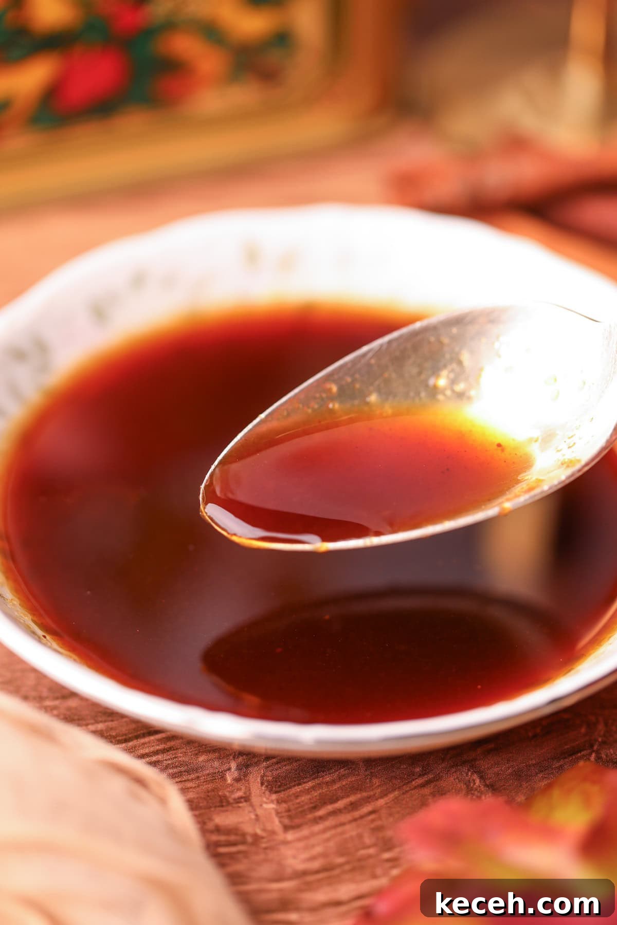 Apple and Brown Sugar Syrup Recipe for Pancakes & Coffee 8 apple brown sugar syrup in a bowl with a silver spoon.
