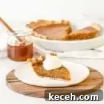 Classic Honey Pie Recipe: Sweet, Buttery Homemade Tart 4 slice of honey pie on a plate with the rest of the pie and a jar of honey in the background