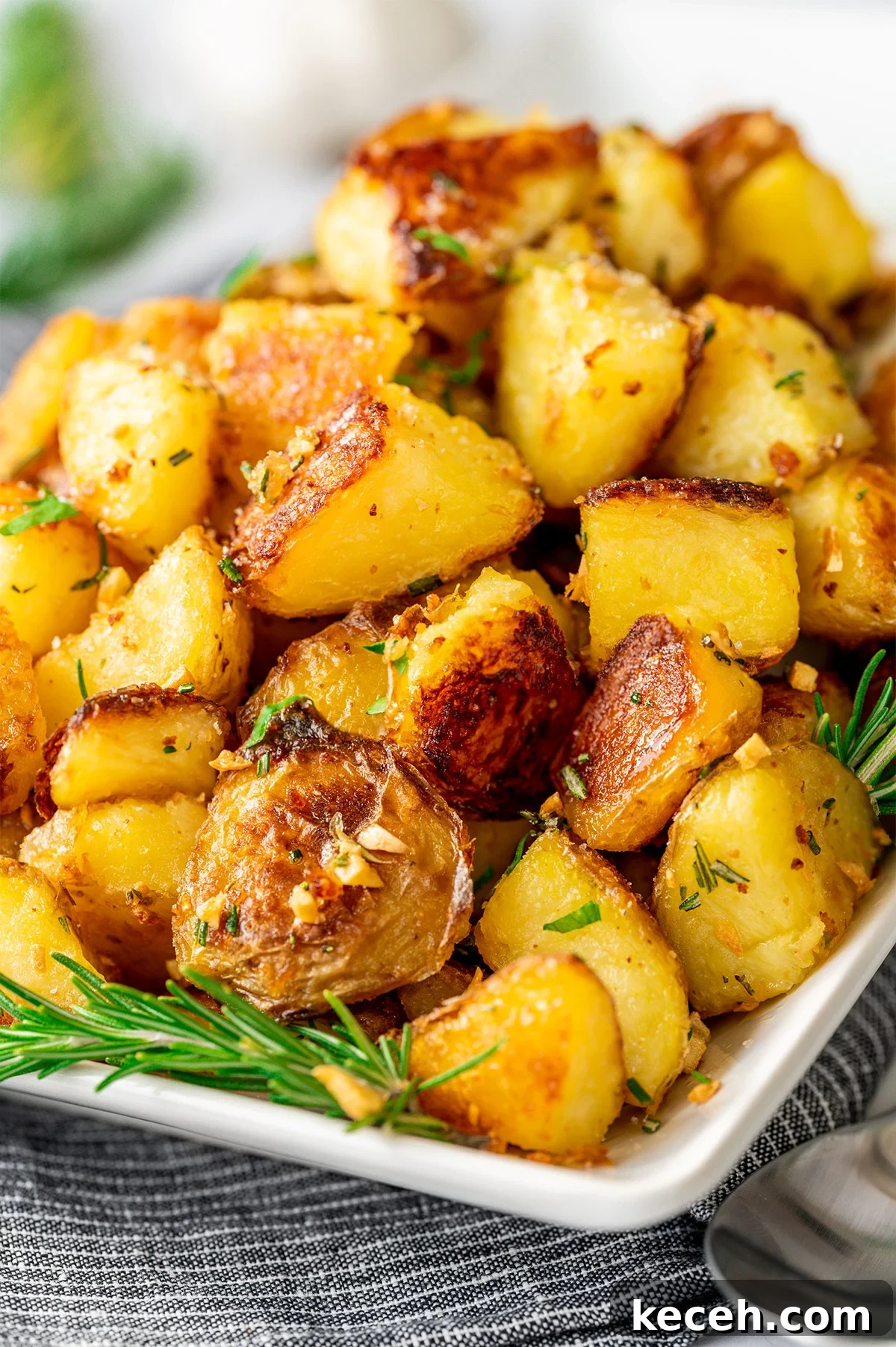 Crispy Rosemary Roasted Potatoes Recipe 2 Rosemary Garlic Potatoes served on a white rectangular platter.