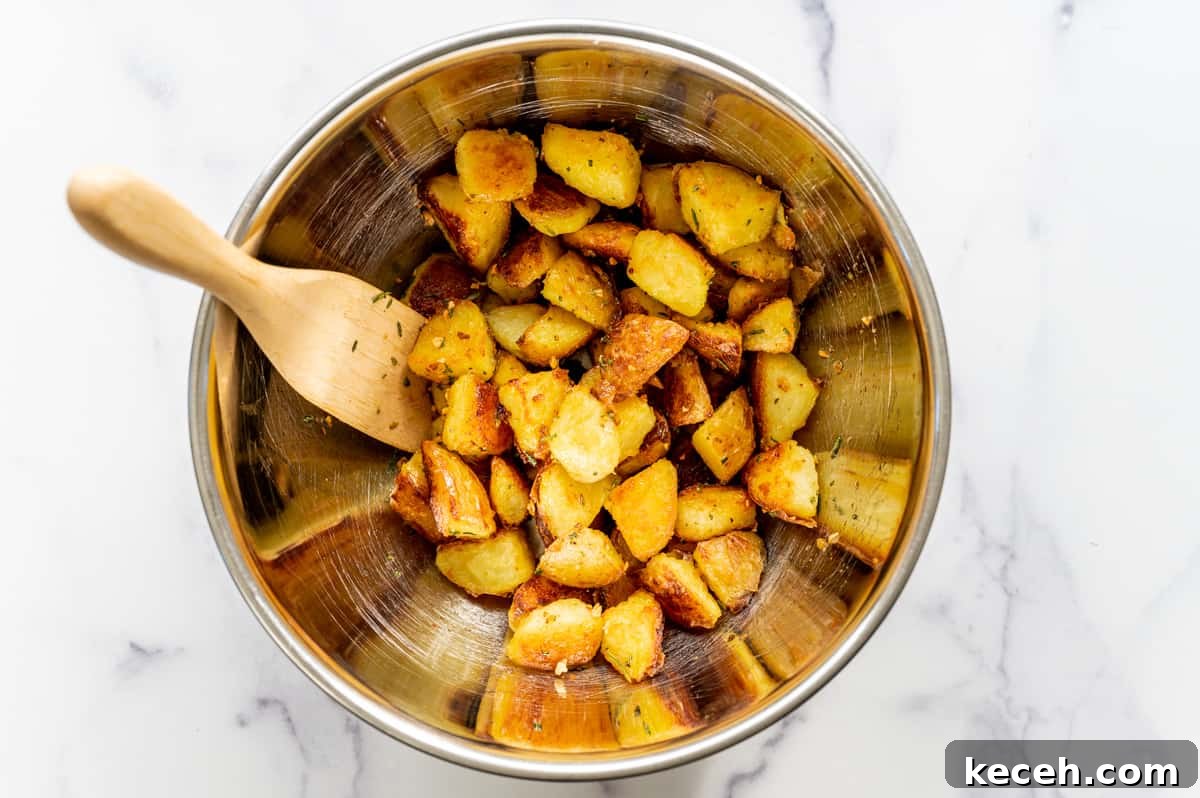 Crispy Rosemary Roasted Potatoes Recipe 13 roasted potatoes tossed with seasoning ready to transfer to platter