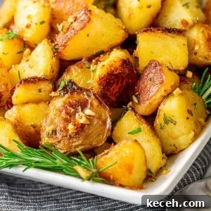 Crispy Rosemary Roasted Potatoes Recipe 14 Rosemary Roasted Potatoes on a white platter.