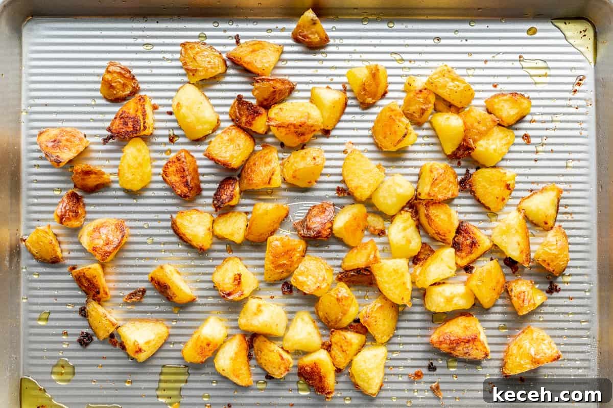 Crispy Rosemary Roasted Potatoes Recipe 9 roasted potatoes on rimmed baking sheet.