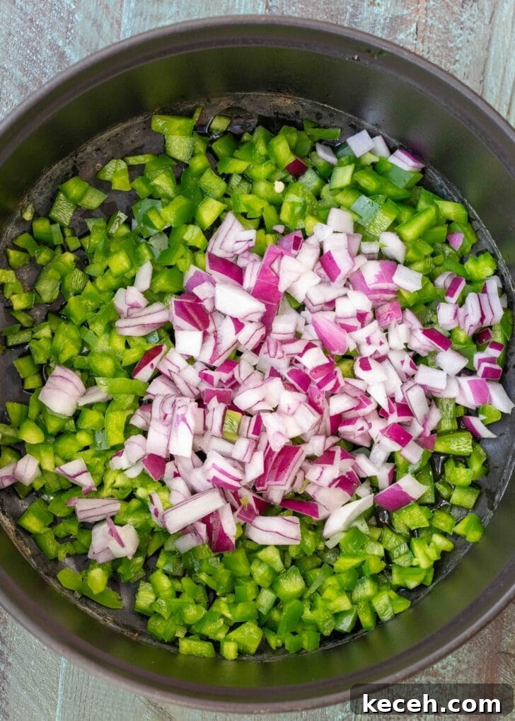 Fiery Chicken Soup Recipe for Bold, Comforting Flavor 5 chopped bell pepper, jalapenos, and red onions in a pot
