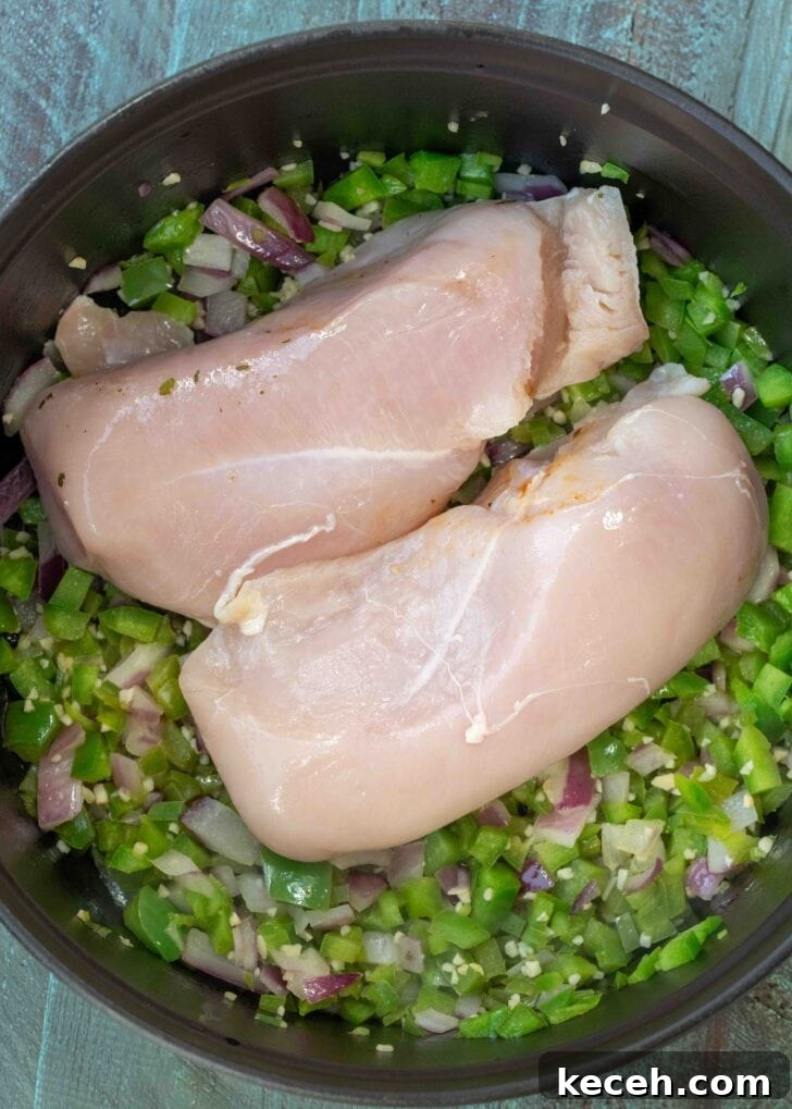 Fiery Chicken Soup Recipe for Bold, Comforting Flavor 6 chicken breasts added atop sauteed bell peppers, jalapenos, red onions, and garlic