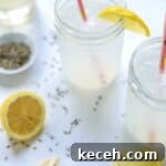 two ball jars filled with lavender lemonade and pink straws