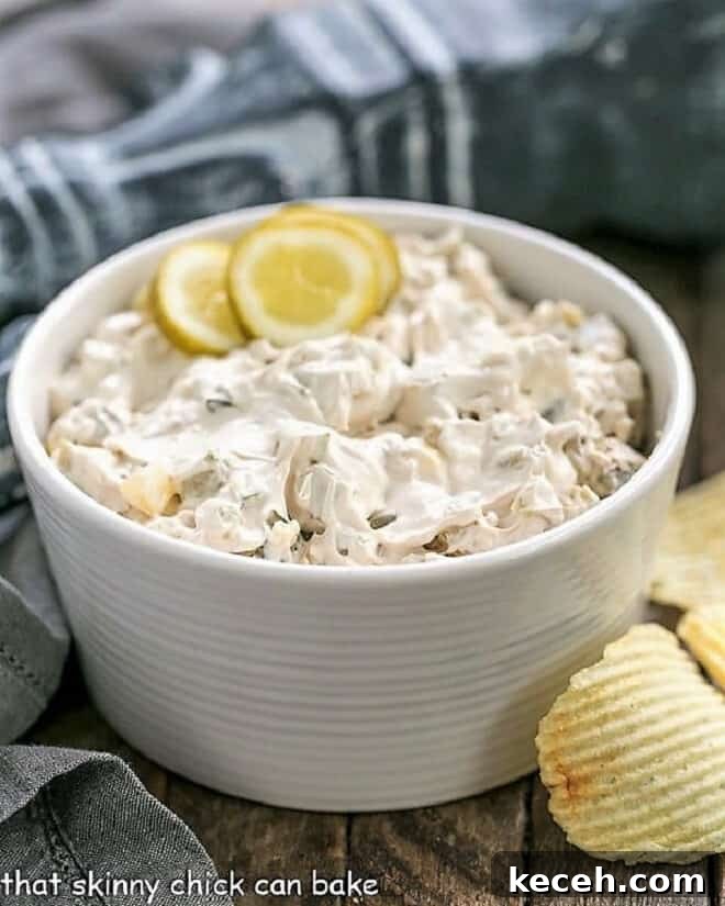 Easy Dill Pickle Dip - Get prepared for rave reviews from this Easy Dip Recipe! Only 5 ingredients! Easy Dill Pickle Dip in a white bowl garnished with pickle slices.
