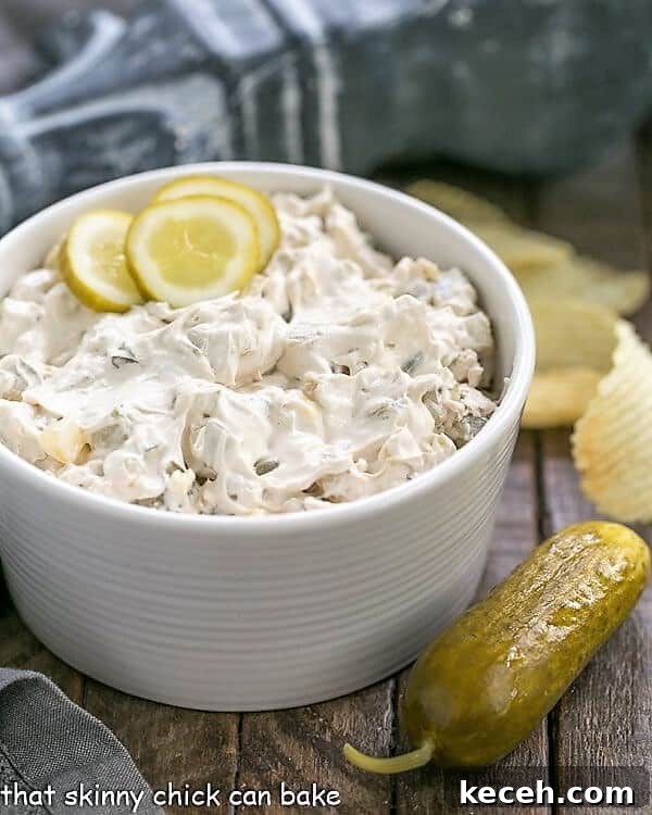 Easy Dill Pickle Dip - Get prepared for rave reviews! Only 5 ingredients! Easy Dill Pickle Dip in a serving bowl with a pickle and ruffled chips.