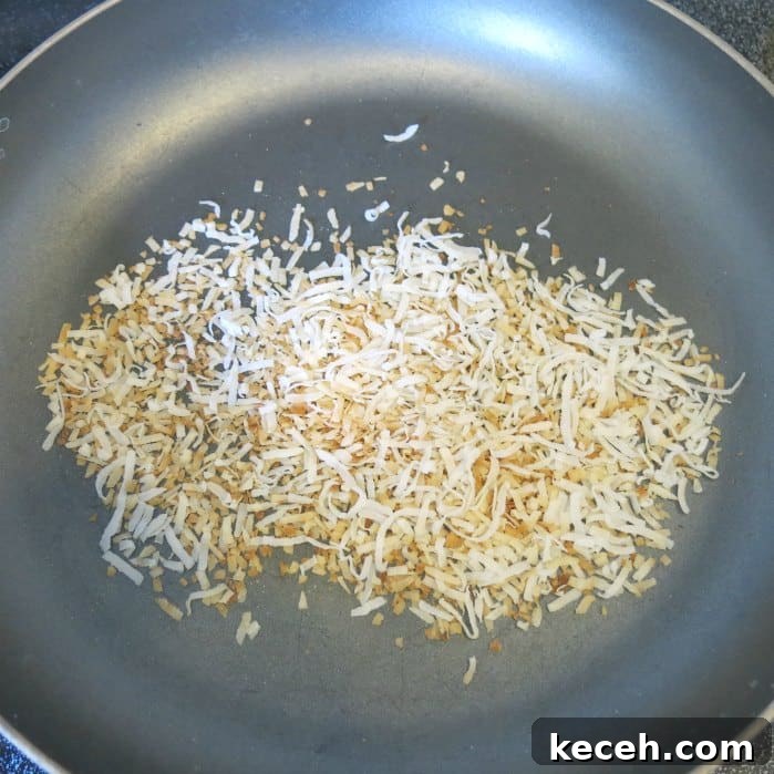 Toasted coconut in frying pan.