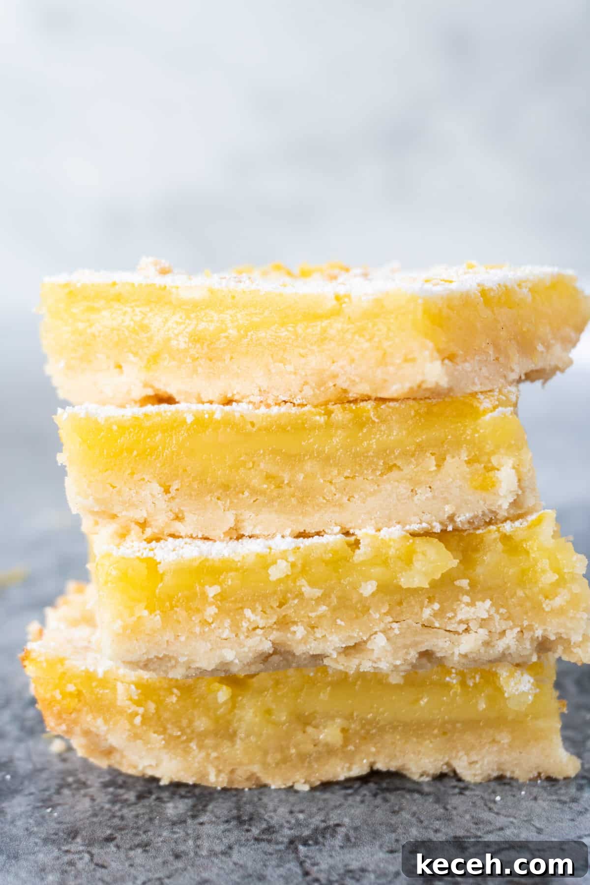 Classic Old-Fashioned Lemon Squares Recipe for Bright Dessert 2 4 lemon squares stacked on top of one another showing the cross section of the crust and delicious filling.