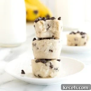 Three banana chocolate chip frozen bites stacked on a white plate.