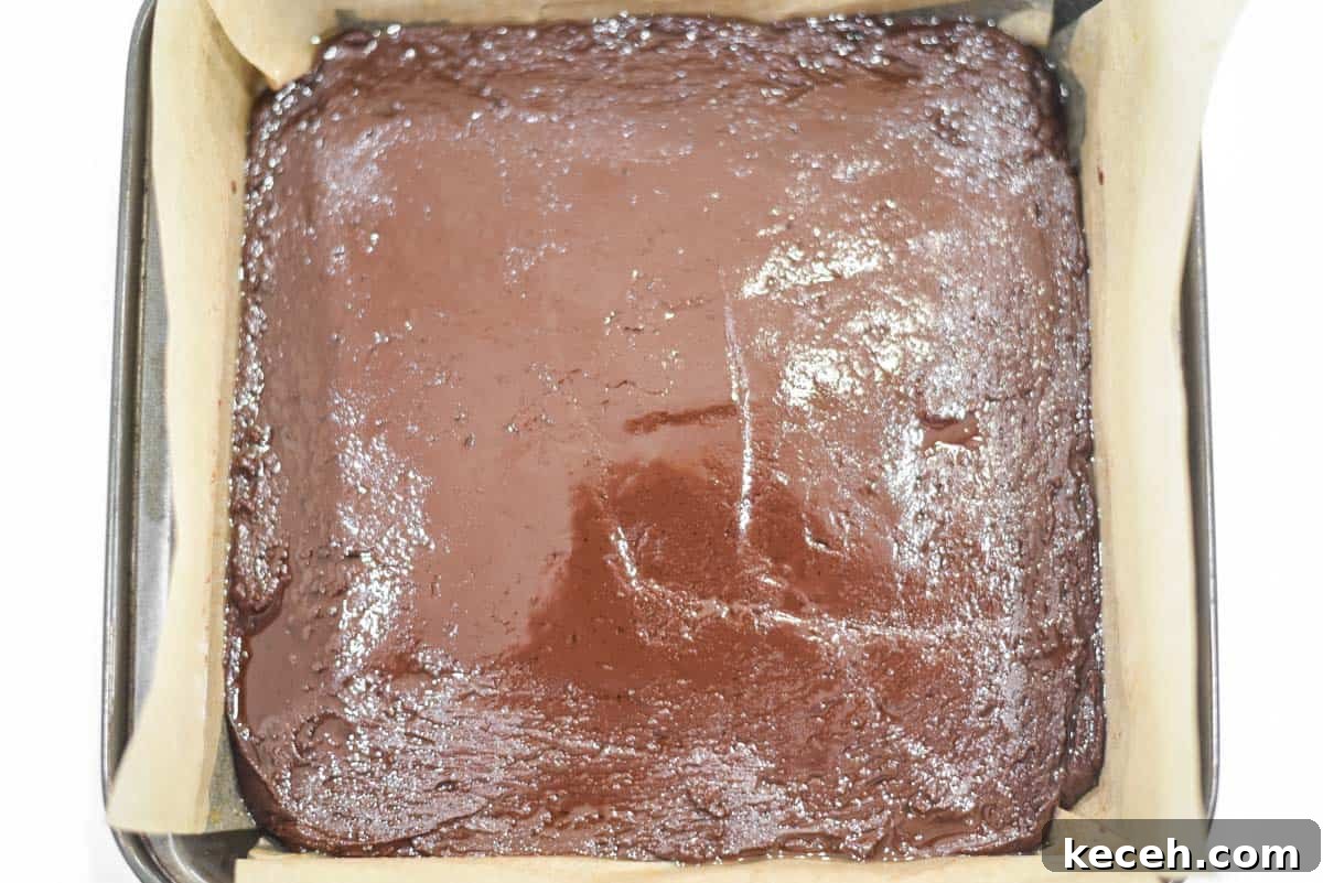 Decadent Baileys Chocolate Fudge Recipe 6 Fudge mixture in 8x8 pan lined with parchment paper.