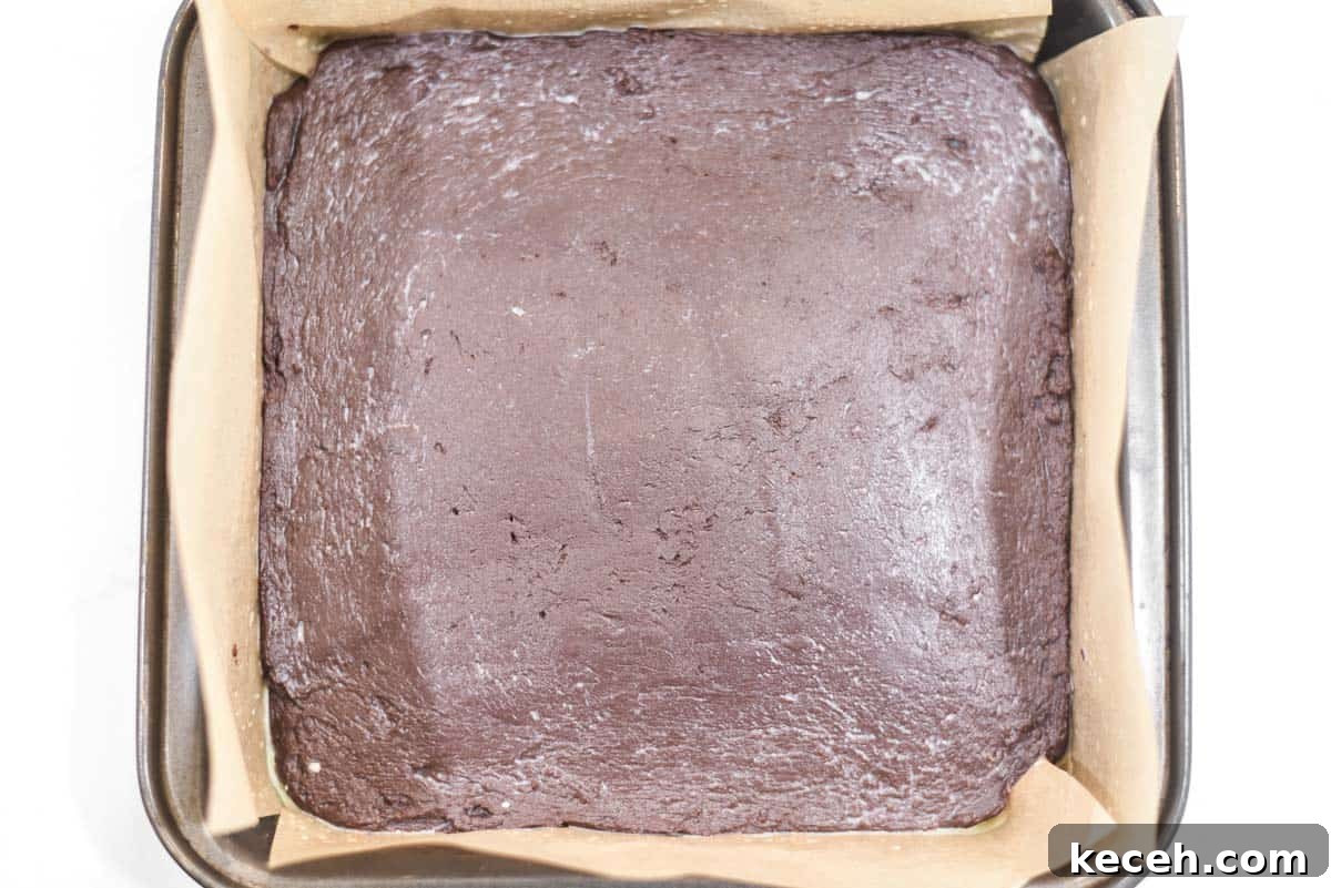 Decadent Baileys Chocolate Fudge Recipe 7 Baileys fudge in pan with parchment paper.