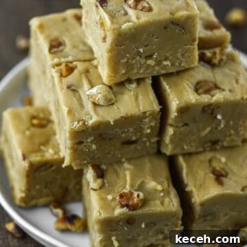 Maple walnut fudge stacked on top of plate