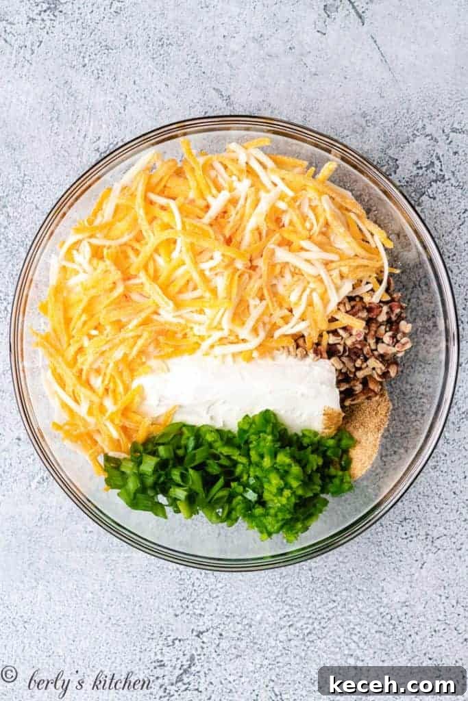 Spicy Jalapeño Cheese Ball Recipe for Parties 3 Cream cheese, peppers, and other ingredients in a mixing bowl.