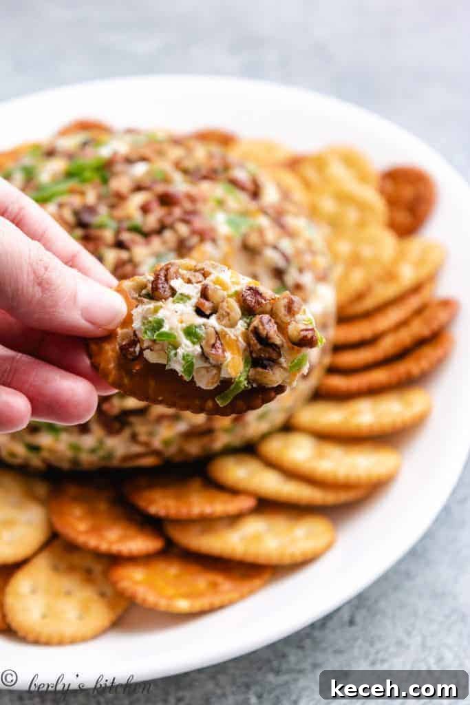 Spicy Jalapeño Cheese Ball Recipe for Parties 6 A cracker coated with a scoop of the snack.