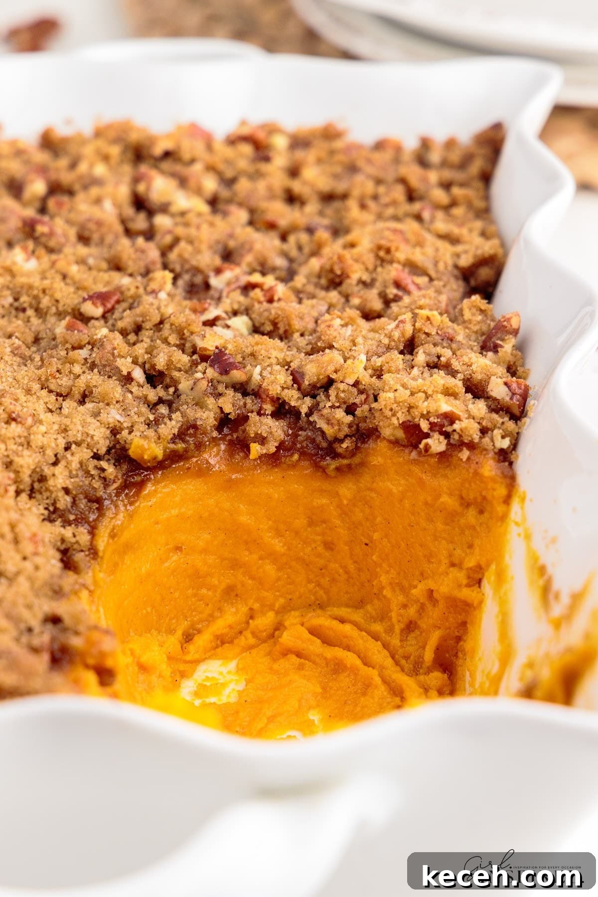 Irresistible Sweet Potato Soufflé Recipe for Holiday Desserts 13 A serving of Sweet Potato Souffle missing from a decorative pan.