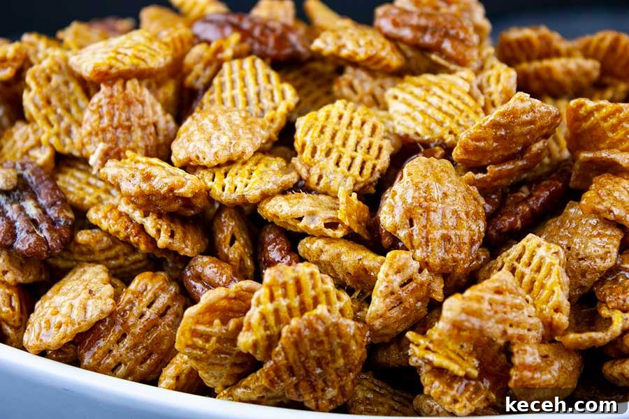 Praline Crunch Snack Mix in a white bowl.