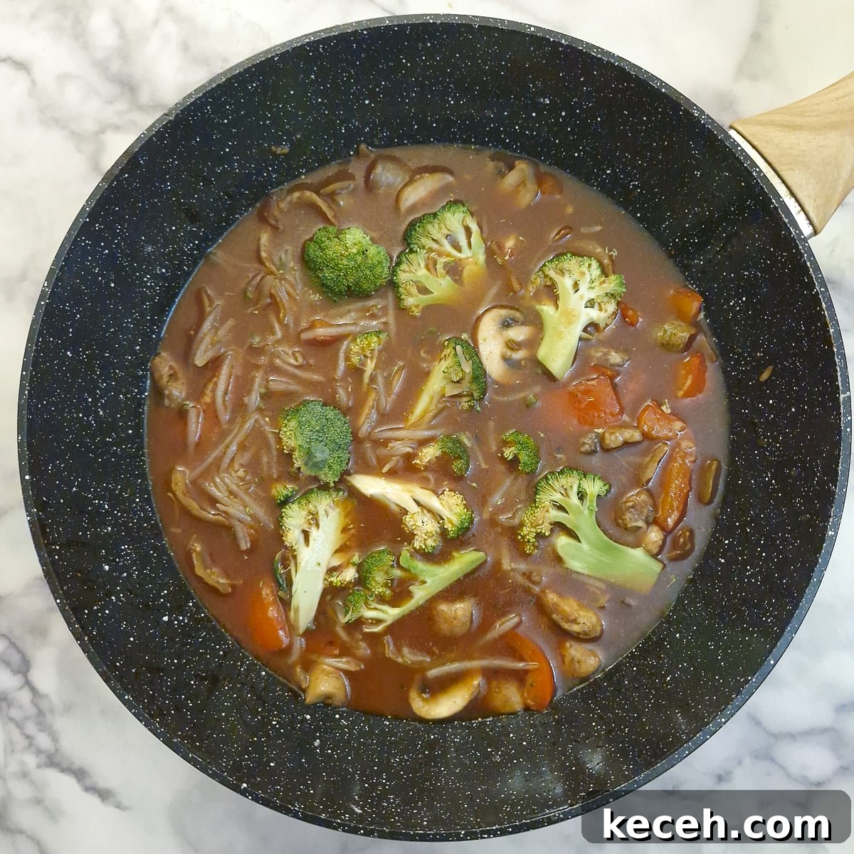 Sauce, broccoli and bean sprouts adde to the wok.