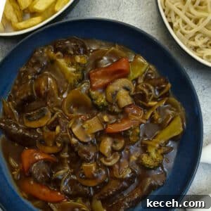 A serving dish filled with rump steak strips in a thick garlic sauce.
