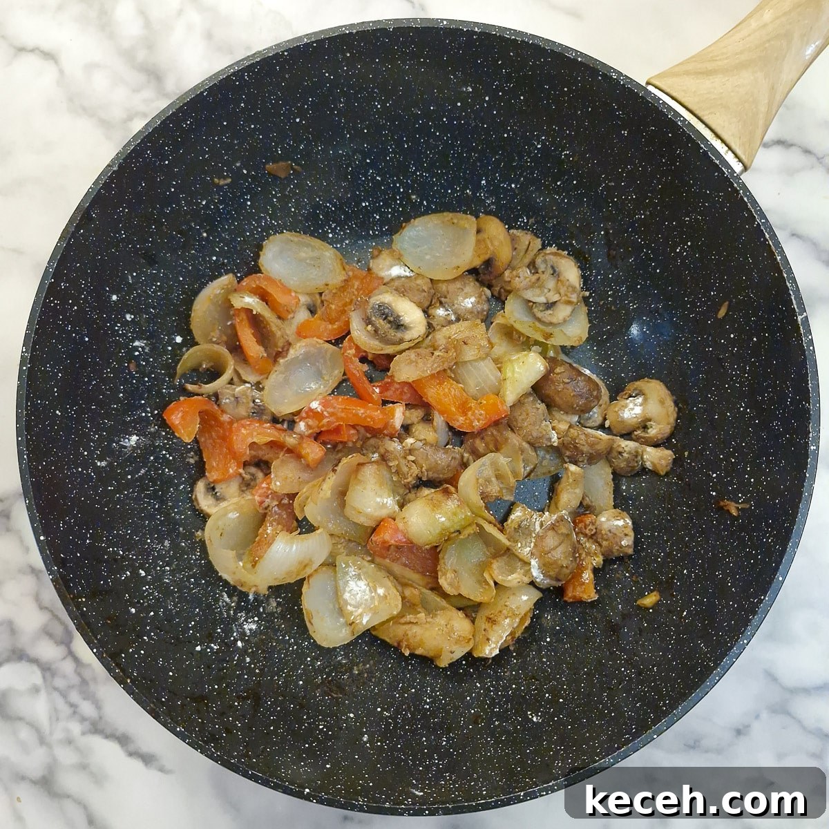 Cornflour stirred into the vegetables in a wok.