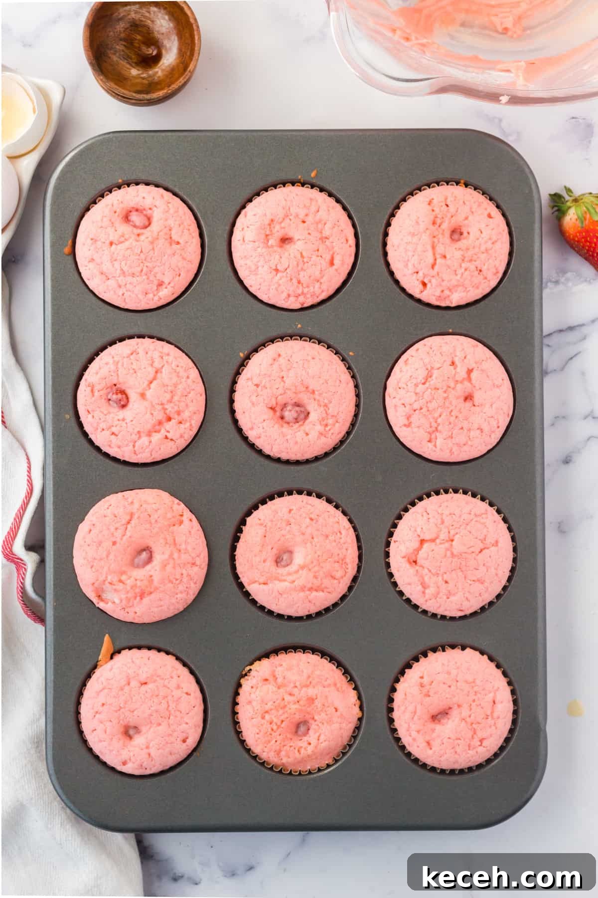 Strawberry-Filled Cupcakes with Fresh Strawberry Filling 8 Freshly baked strawberry cupcakes in muffin tin