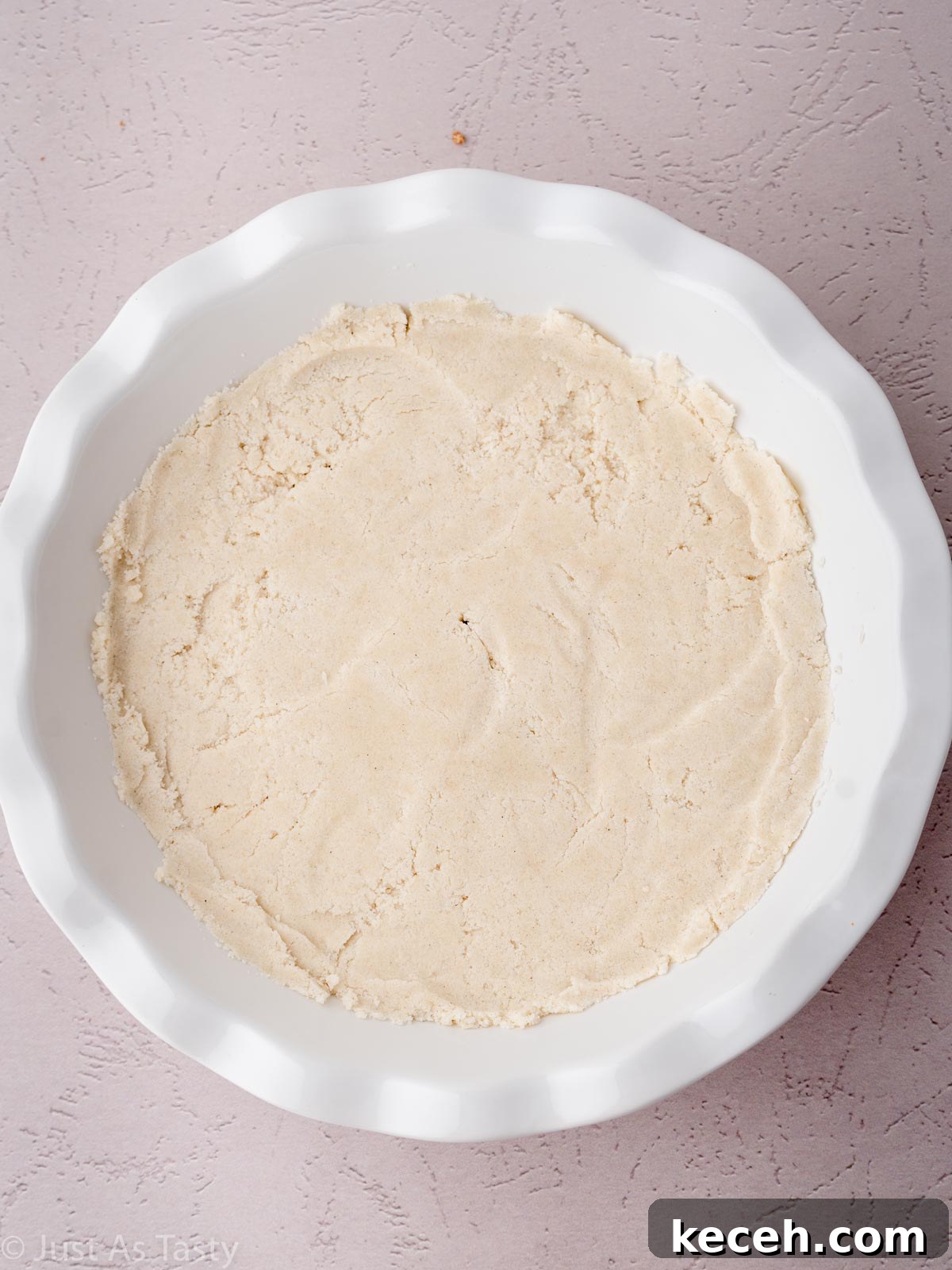Pie crust in a white pie dish.