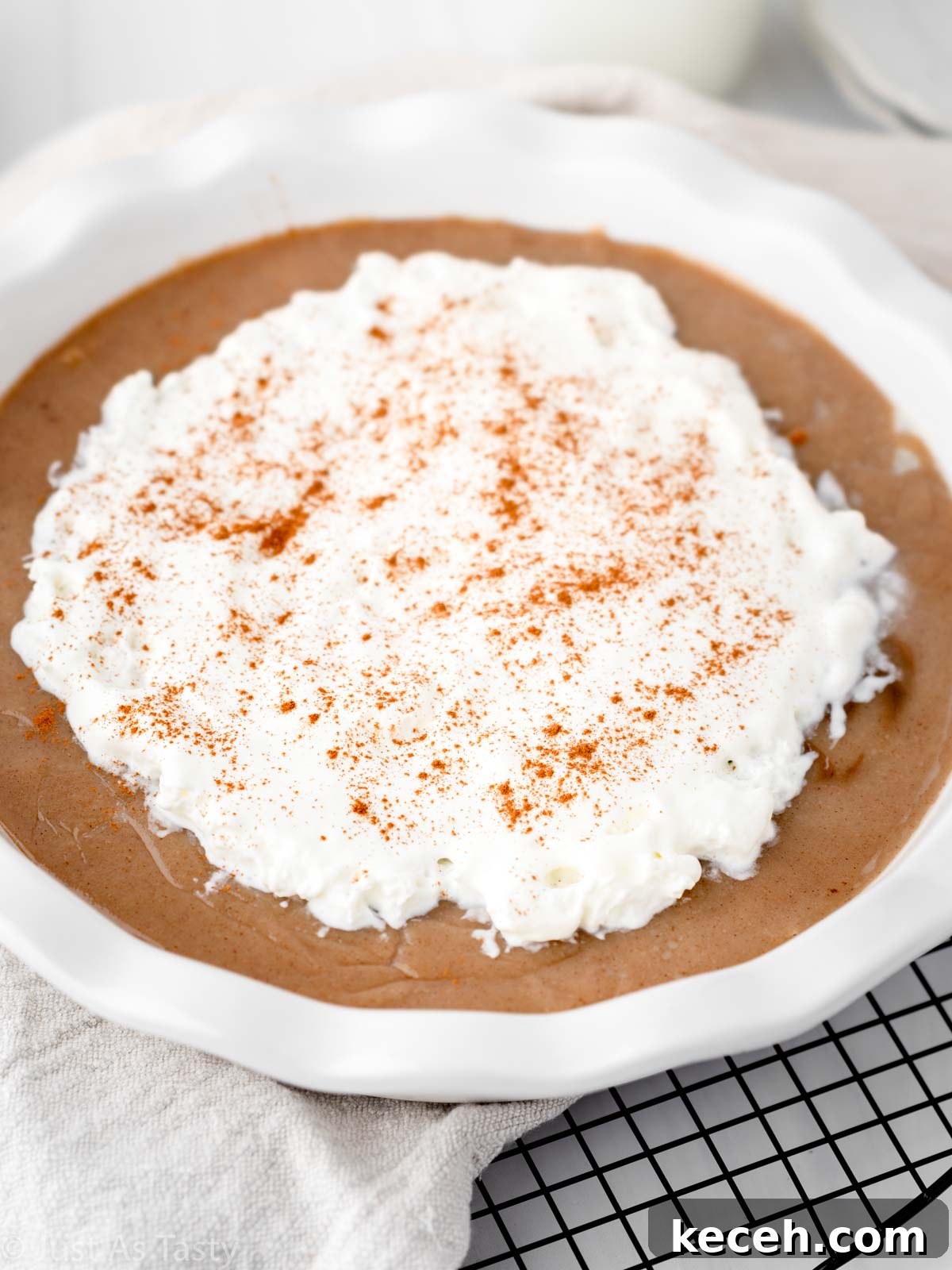Close-up of butterscotch pie topped with whipped cream.
